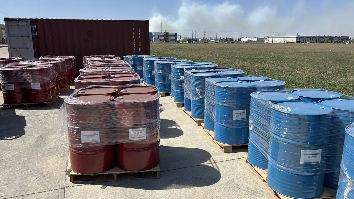 Pallets of blue SPC-10062 polyol drums and red MDI drums unloaded from a 20-ft container at a North American panel producer